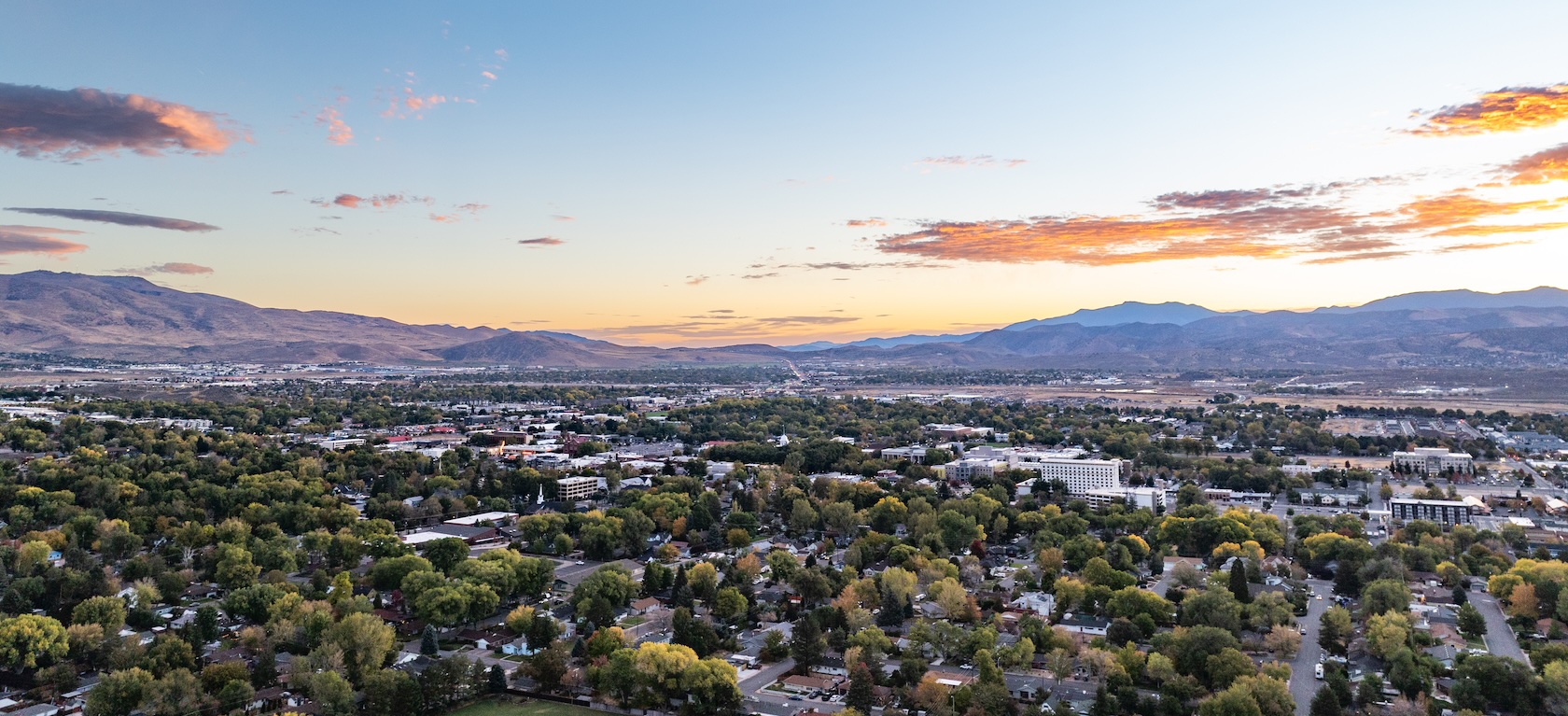 A Nevada valley community at sunset with the Sierra beyond